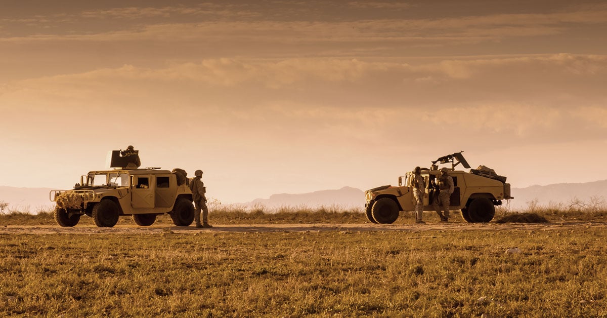 Military soldiers using satellite communications equipment