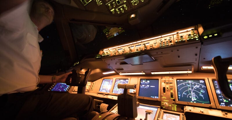 Pilot in cockpit using the Iridium LEO satellite network during flight operations.