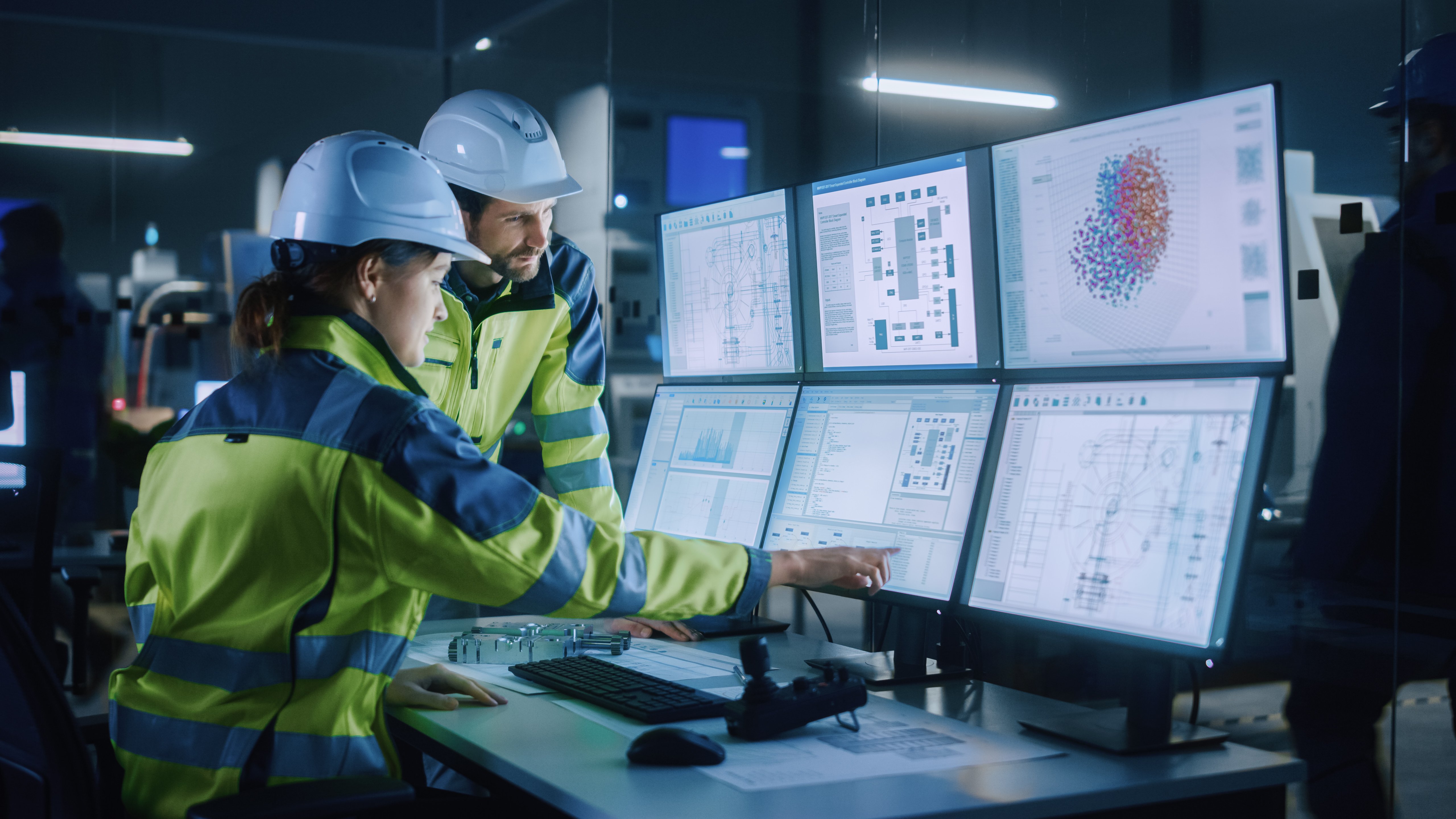 Emergency Services workers reviewing data across several monitors