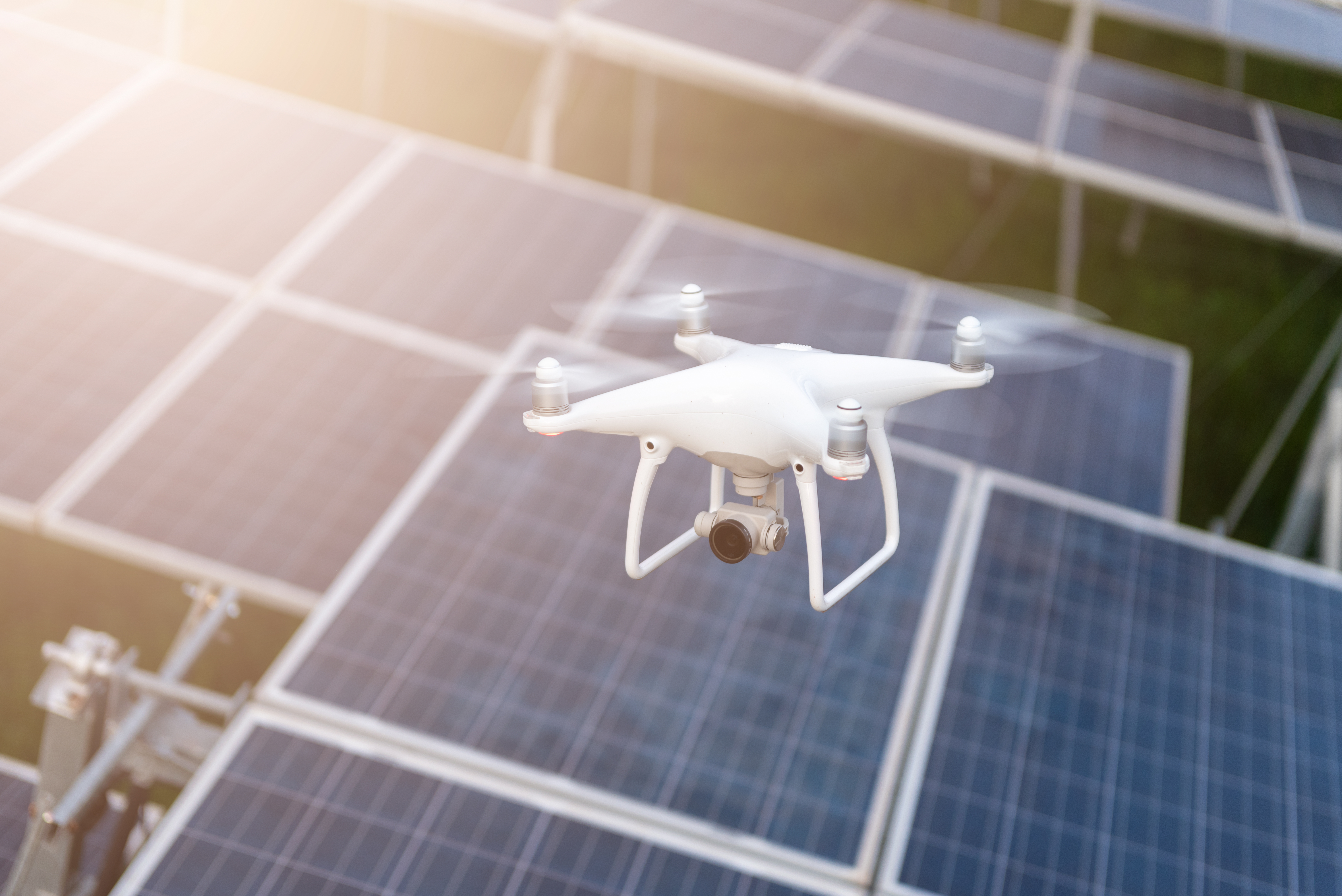 A drone flying over solar panels